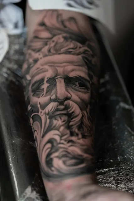 Black and gray realism Greek statue portrait on a forearm, fresh
